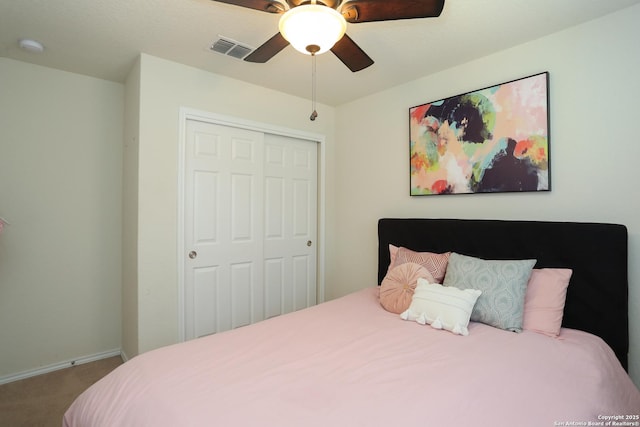 bedroom featuring baseboards, visible vents, a ceiling fan, carpet flooring, and a closet