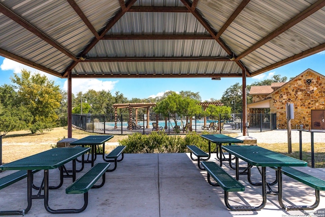 view of home's community featuring fence, a pool, and a gazebo