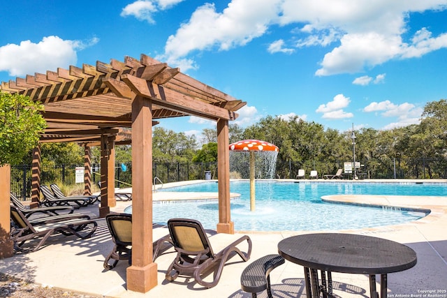 pool with a patio area, fence, and a pergola