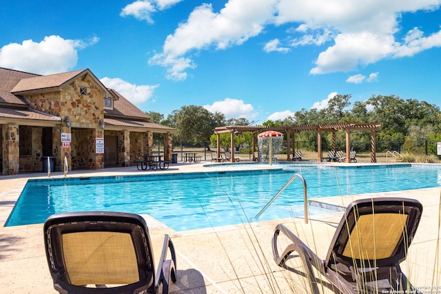 pool with a patio, fence, and a pergola