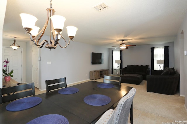 dining space with visible vents, baseboards, and ceiling fan with notable chandelier