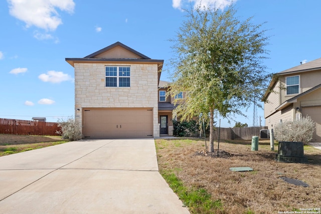 traditional-style house with an attached garage, stone siding, fence, and concrete driveway