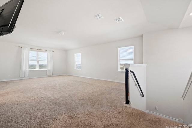 unfurnished room featuring light carpet, baseboards, and visible vents