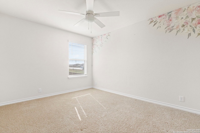 spare room featuring ceiling fan, baseboards, and light colored carpet