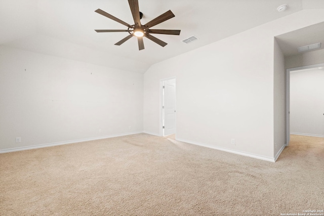 unfurnished room with light colored carpet, vaulted ceiling, visible vents, and ceiling fan