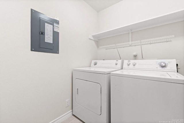 laundry room featuring laundry area, light tile patterned floors, electric panel, baseboards, and separate washer and dryer