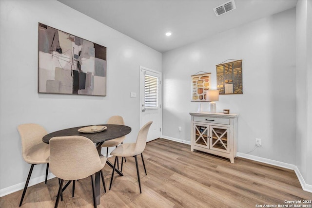 dining room featuring recessed lighting, wood finished floors, visible vents, and baseboards