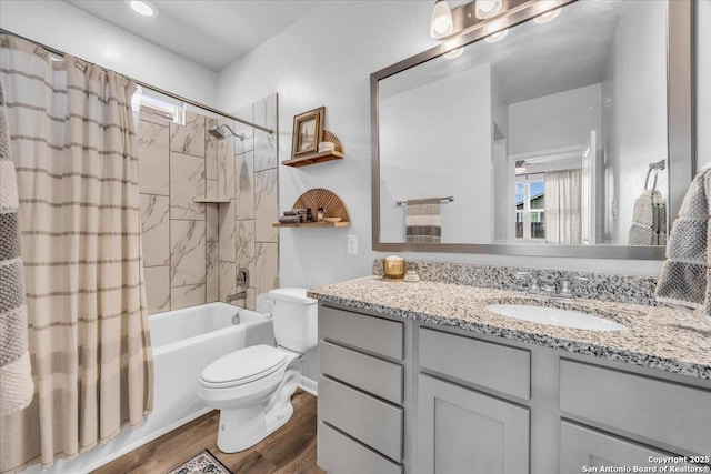 bathroom with toilet, shower / tub combo, wood finished floors, and vanity