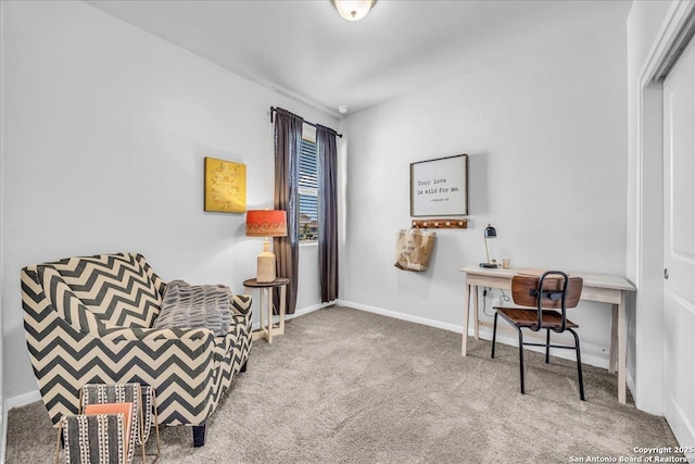 living area featuring carpet and baseboards