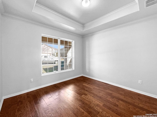 12518 Ponder, San Antonio, TX 78245 - spare room featuring dark wood finished floors, visible vents, a tray ceiling, and ornamental molding