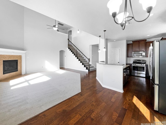 12518 Ponder, San Antonio, TX 78245 - kitchen featuring a fireplace, open floor plan, appliances with stainless steel finishes, and arched walkways