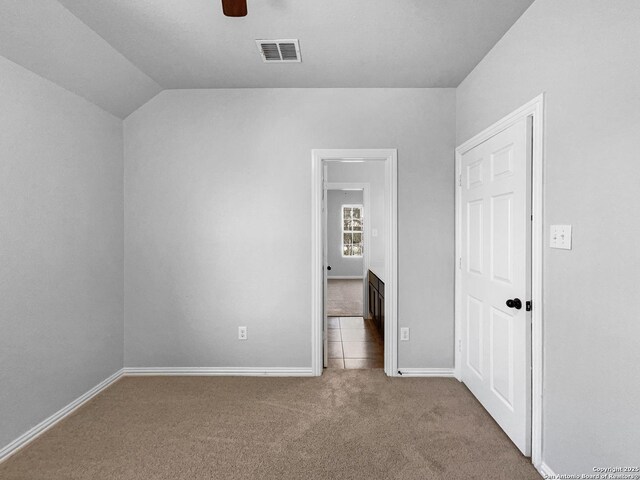 12518 Ponder, San Antonio, TX 78245 - unfurnished bedroom with visible vents, a ceiling fan, carpet floors, baseboards, and vaulted ceiling
