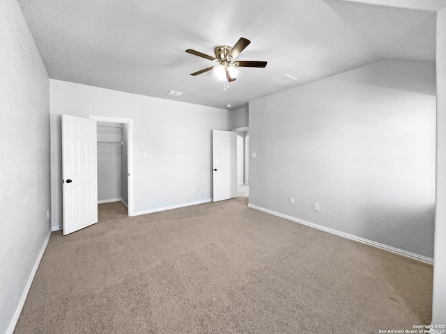 12518 Ponder, San Antonio, TX 78245 - unfurnished bedroom featuring a spacious closet, ceiling fan, baseboards, vaulted ceiling, and carpet flooring