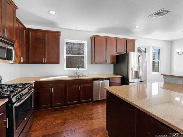 12518 Ponder, San Antonio, TX 78245 - kitchen featuring visible vents, dark wood finished floors, a sink, appliances with stainless steel finishes, and a wealth of natural light