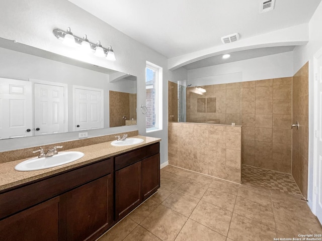 12518 Ponder, San Antonio, TX 78245 - bathroom featuring double vanity, walk in shower, visible vents, and a sink
