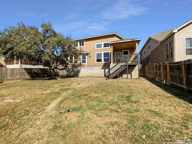 12518 Ponder, San Antonio, TX 78245 - back of house with a yard, a fenced backyard, and stairs