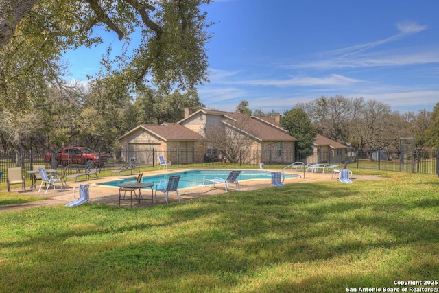 view of pool with a yard, fence, and a fenced in pool