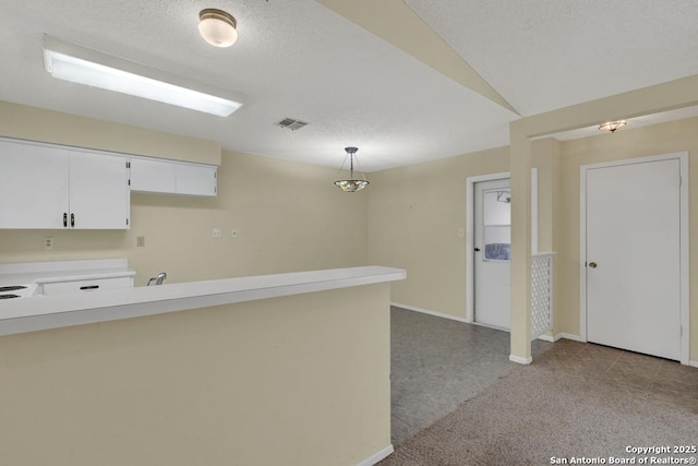 interior space featuring baseboards, visible vents, and a textured ceiling