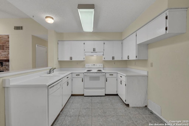 kitchen with white appliances, visible vents, white cabinets, under cabinet range hood, and a sink