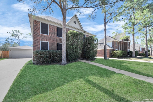 view of front of house featuring a garage, brick siding, an outdoor structure, and a front yard