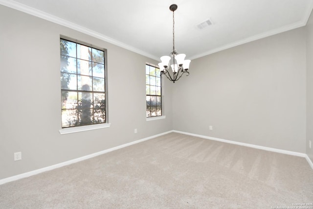 carpeted spare room with visible vents, crown molding, baseboards, and an inviting chandelier