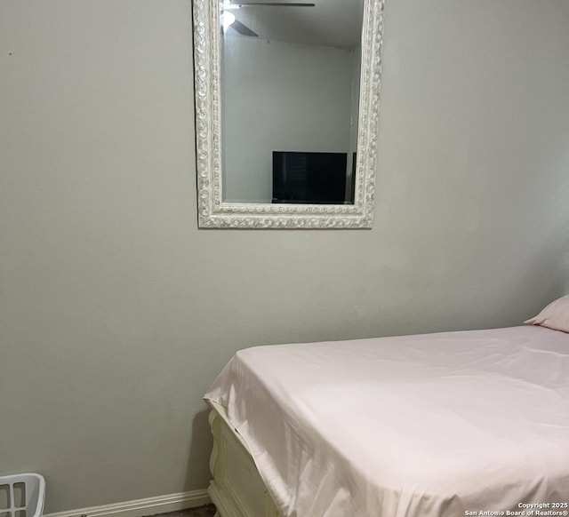 bedroom featuring a ceiling fan and baseboards