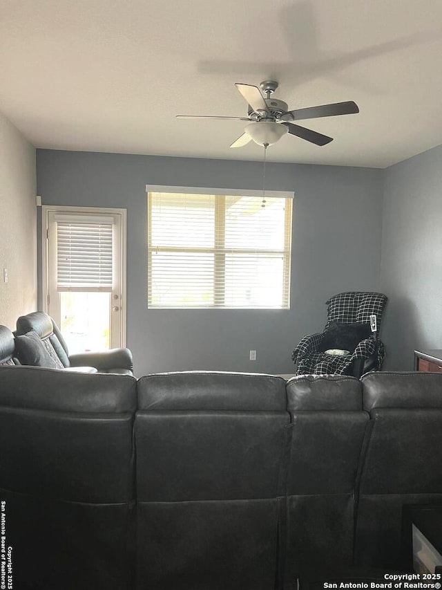 living area with ceiling fan