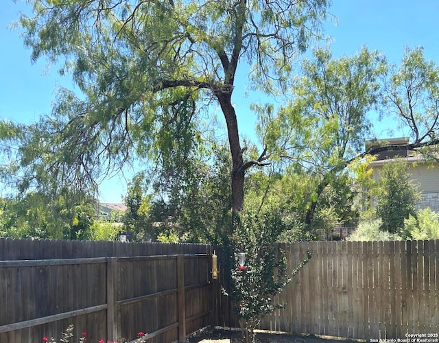 view of gate featuring a fenced backyard