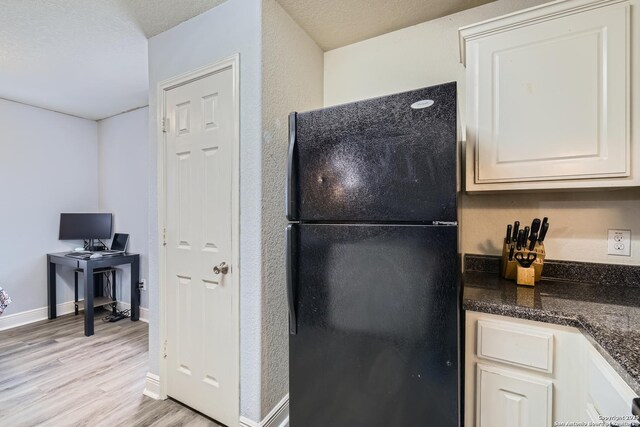 11351 Fire Cyn, San Antonio, TX 78252 - kitchen featuring a textured ceiling, light wood-style flooring, freestanding refrigerator, and baseboards