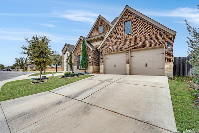 view of front facade featuring stone siding, fence, concrete driveway, and brick siding