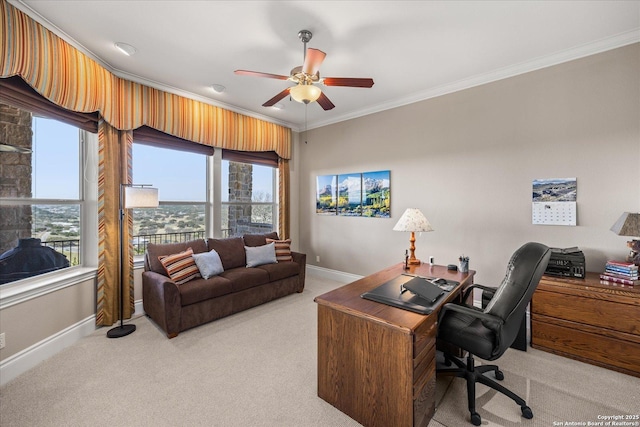 home office with light carpet, ceiling fan, baseboards, and crown molding