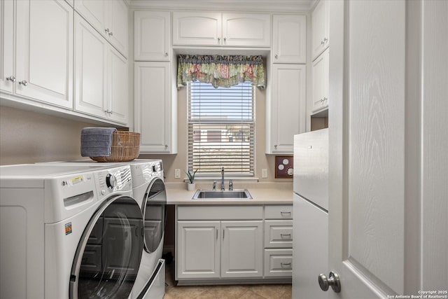 laundry area with cabinet space, a sink, and separate washer and dryer