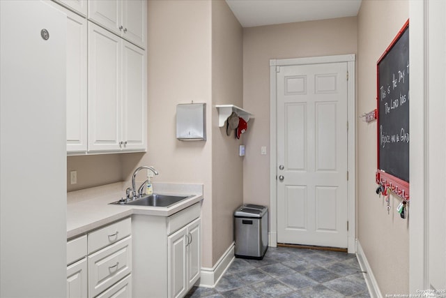 interior space featuring a sink and baseboards