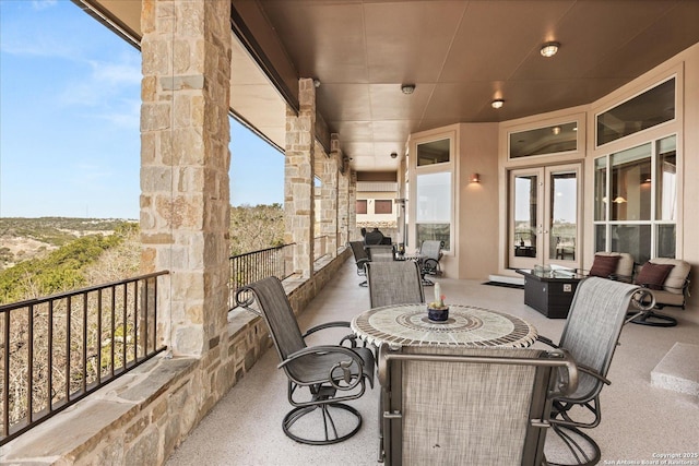 view of patio / terrace with french doors and a balcony