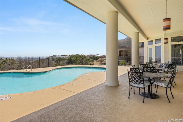 community pool featuring a patio area and fence