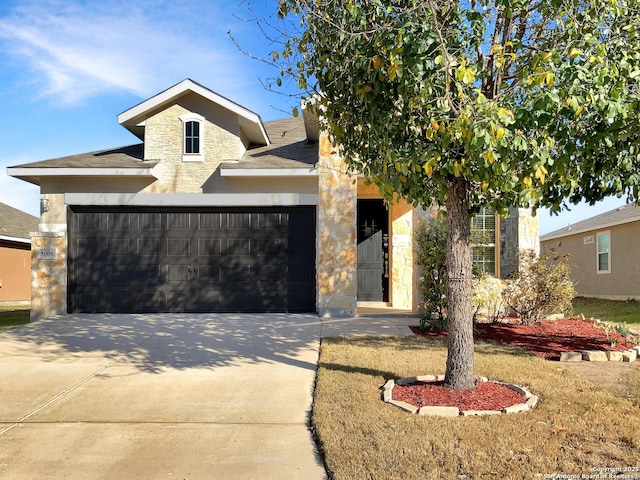 view of front of house featuring stone siding, driveway, an attached garage, and stucco siding