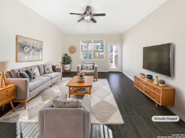 living area featuring lofted ceiling, ceiling fan, baseboards, and wood finish floors