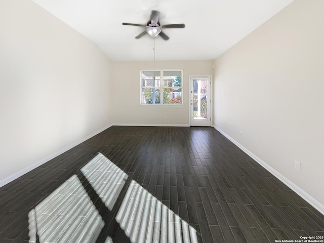 unfurnished room featuring baseboards, ceiling fan, and wood tiled floor