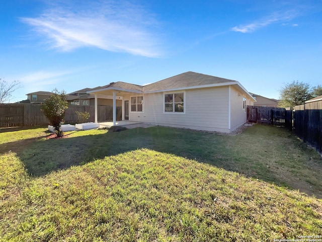 back of house featuring a patio area, a fenced backyard, and a yard