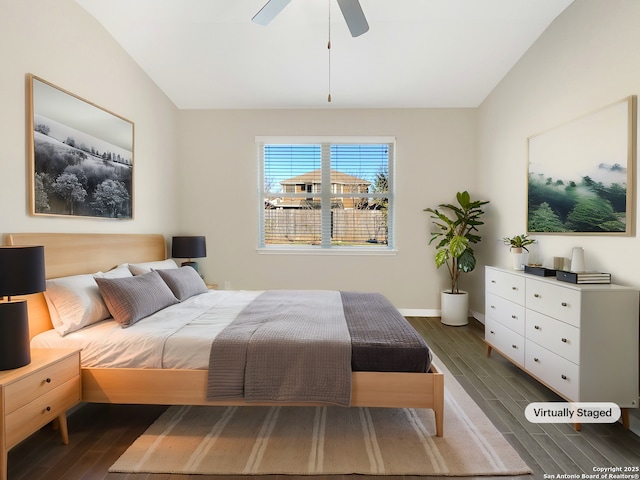 bedroom with ceiling fan, vaulted ceiling, baseboards, and wood finished floors