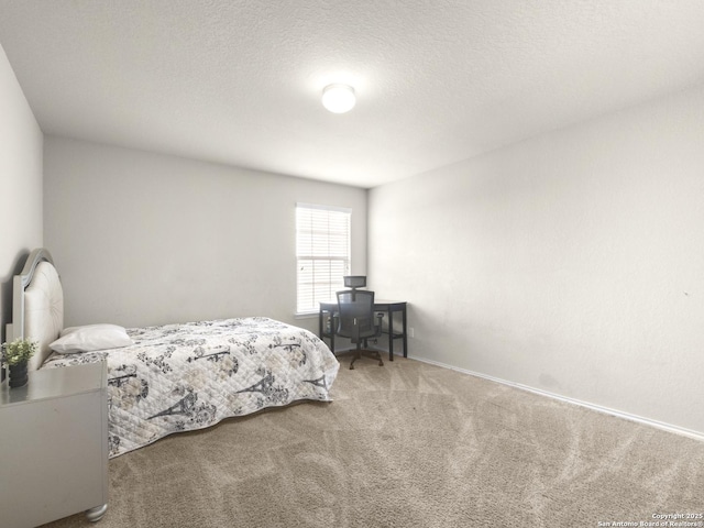 bedroom with carpet floors and a textured ceiling