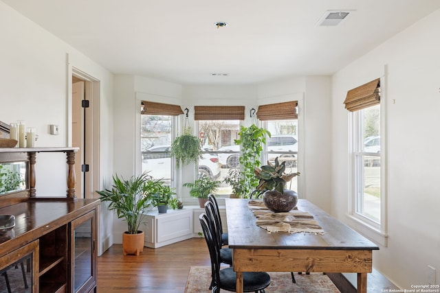 office space featuring wood finished floors and visible vents