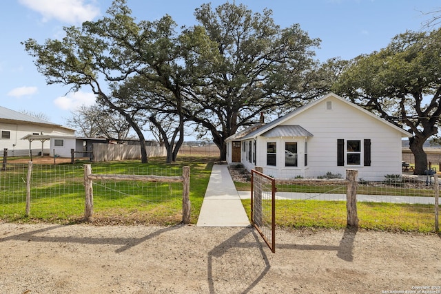 bungalow featuring a fenced front yard and a front lawn