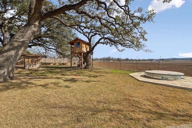 view of yard with fence and a playground