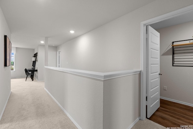 hall with carpet, baseboards, and recessed lighting