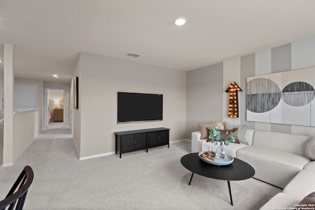 living area featuring recessed lighting, baseboards, visible vents, and light colored carpet