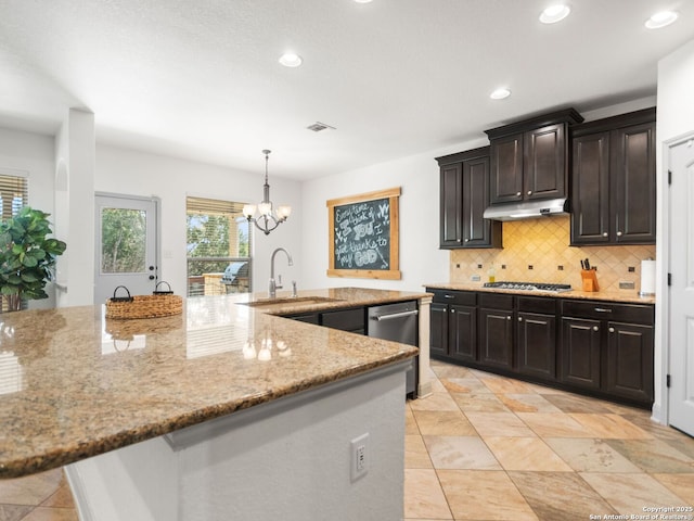 kitchen with light stone countertops, visible vents, stainless steel appliances, under cabinet range hood, and tasteful backsplash