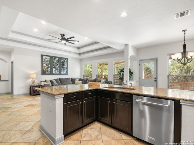 kitchen with visible vents, a sink, a tray ceiling, open floor plan, and dishwasher