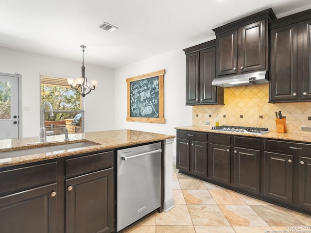 kitchen with visible vents, under cabinet range hood, a sink, appliances with stainless steel finishes, and light stone countertops