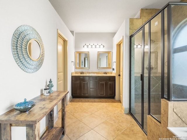 full bath with tile patterned floors, a shower stall, double vanity, and a sink